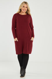 Model Katie wearing size XL of The Pocket Detail Dress in colour Burgundy (Red), from the front, showing the whole outfit