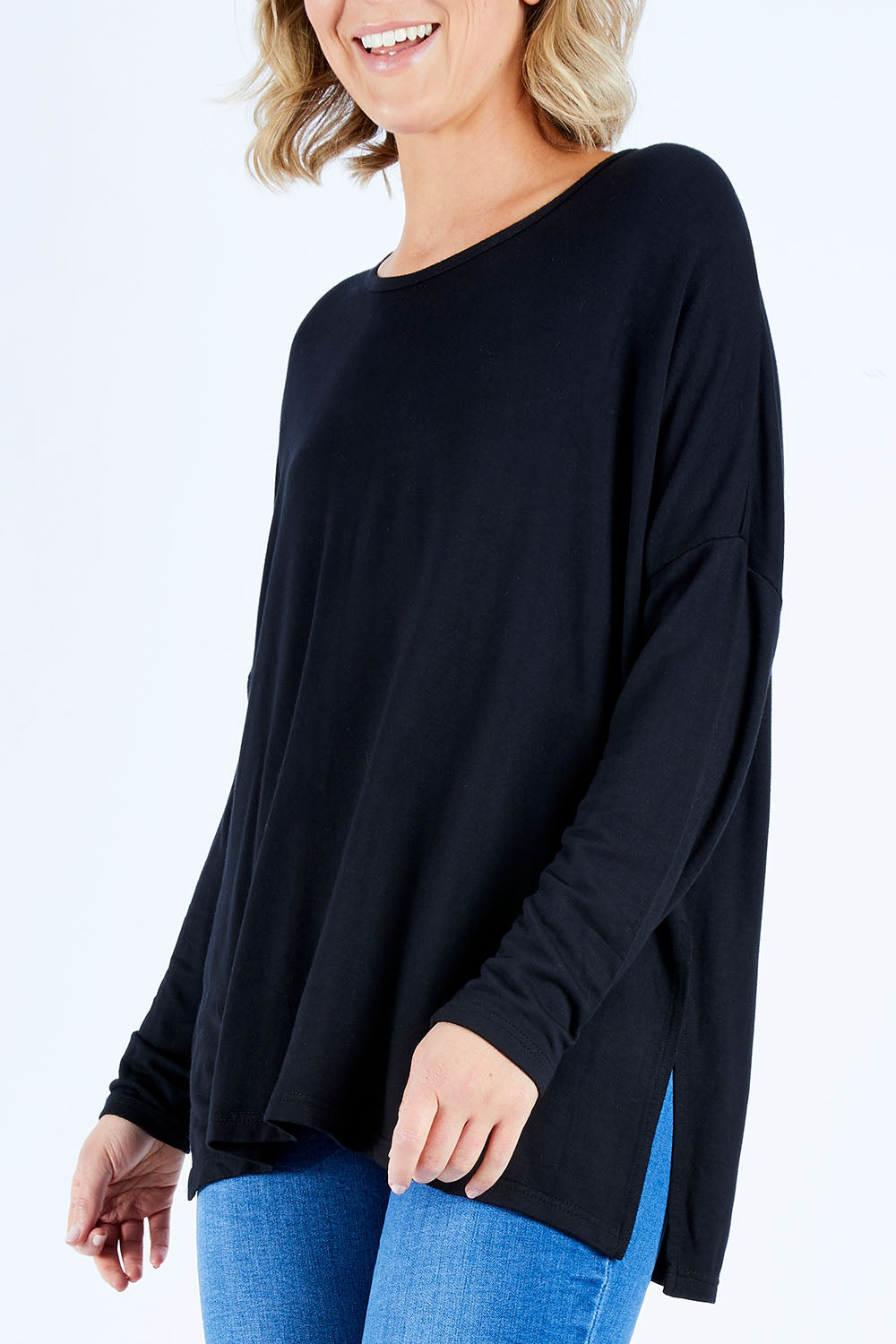 Model Chelsea wearing size S of The Side Split Tunic Top in colour Black (Black), from the front, cropped image
