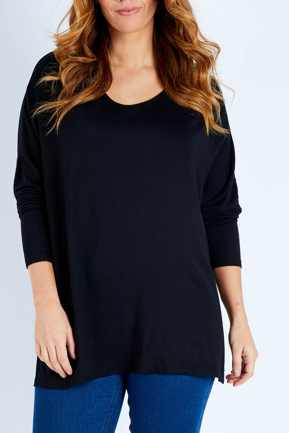 Model Laura wearing size L of The Side Split Tunic Top in colour Black (Black), from the front, cropped image