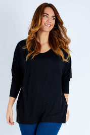 Model Laura wearing size L of The Side Split Tunic Top in colour Black (Black), from the front, cropped image