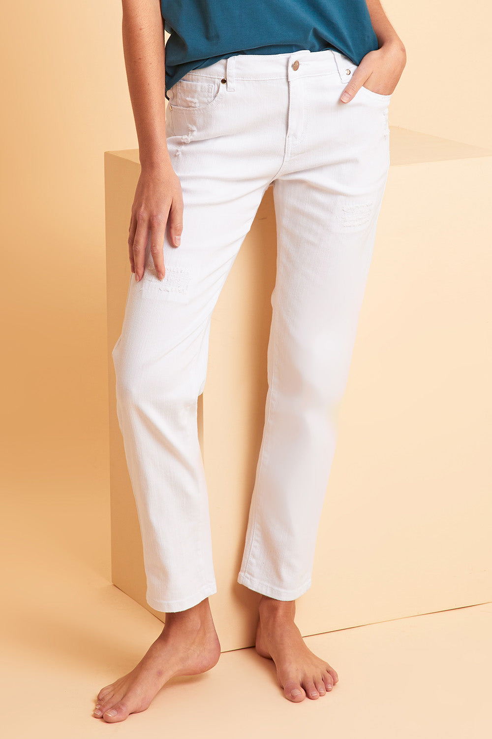 Model Madeline wearing size 10 of The Distressed Boyfriend Slim Leg Jean in colour White (White), from the front, showing the whole outfit