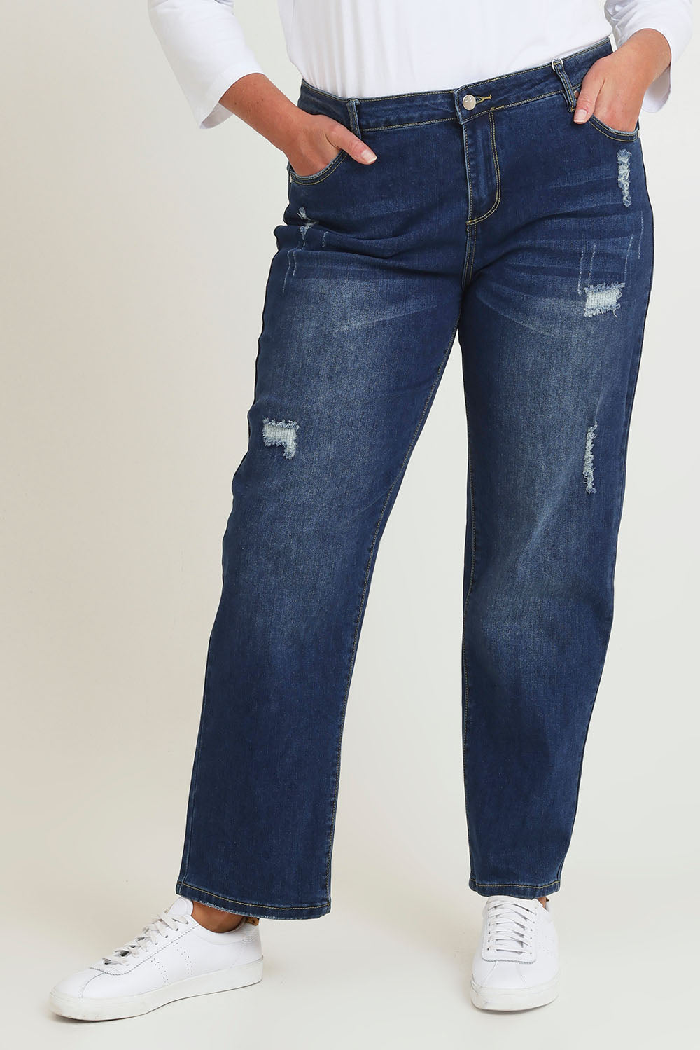 Model Chanel wearing size 16 of The Distressed Boyfriend Jean in colour Mediumblue (Blue), from the front, cropped image