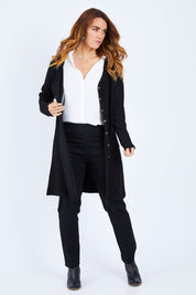 Model Laura wearing size 14 of The Rib Longline Cardi in colour Black (Black), from the front, showing the whole outfit