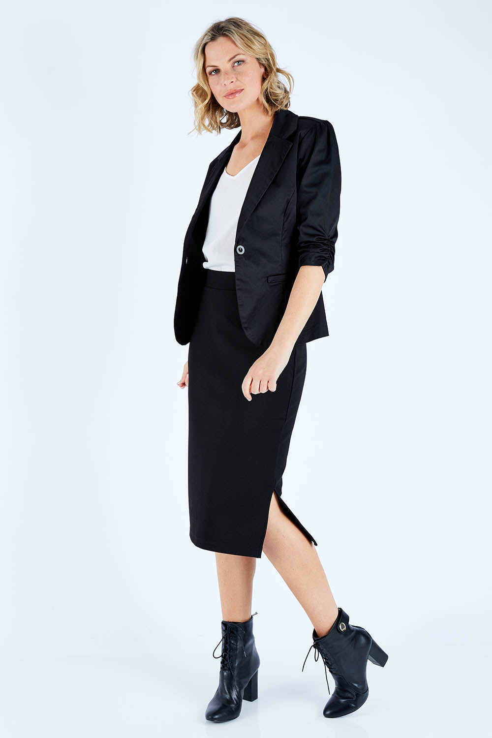 Model Chelsea wearing size 10 of The Midi Ponte Skirt in colour Black (Black), from the front, showing the whole outfit