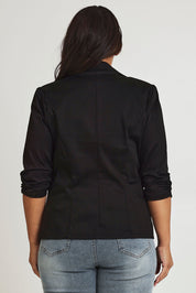 Model Ashleigh wearing size 16 of The Everyday Blazer in colour Black (Black), from the back