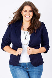 Model Mae wearing size 16 of The Everyday Blazer in colour DarkNavy (Blue), from the front, cropped image