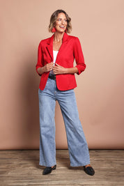 Model Riina wearing size 10 of The Everyday Blazer in colour Firered (Red), from the front, showing the whole outfit