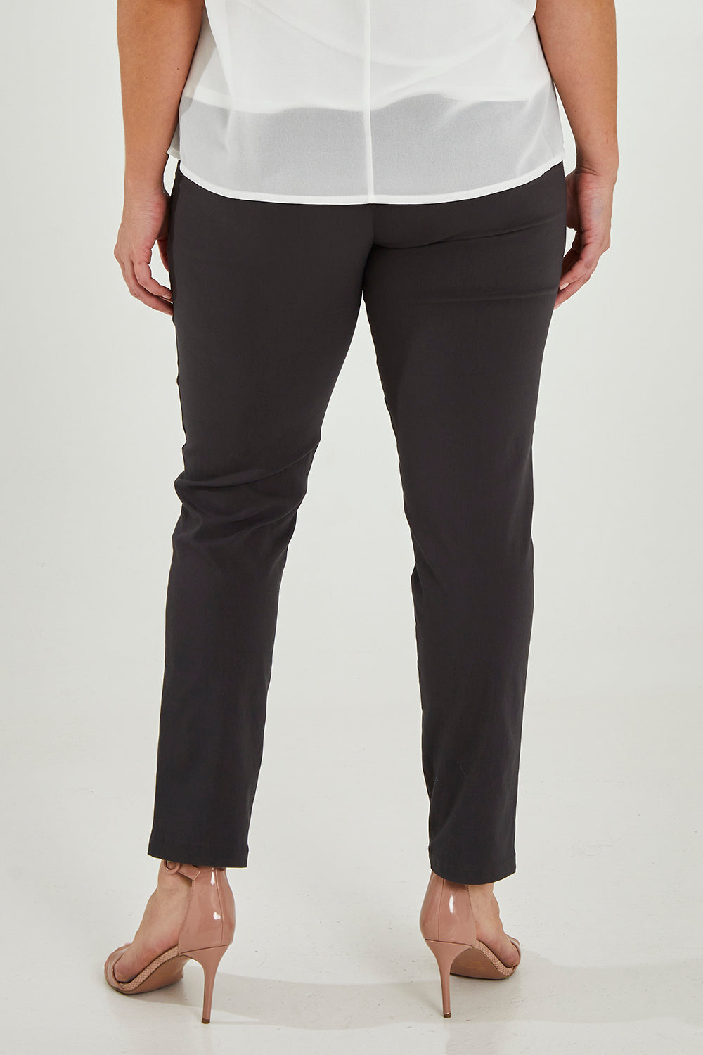 Model Maddy wearing size 16 of The Slim Cut Stretch Pant in colour Charcoal (Grey), from the back