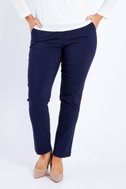 Model Laura wearing size 12 of The Slim Cut Stretch Pant in colour Navy (Blue), from the front, cropped image