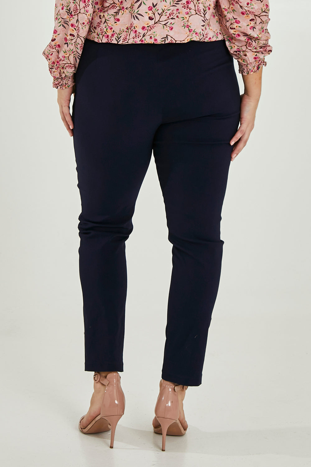 Model Maddy wearing size 16 of The Slim Cut Stretch Pant in colour Navy (Blue), from the back