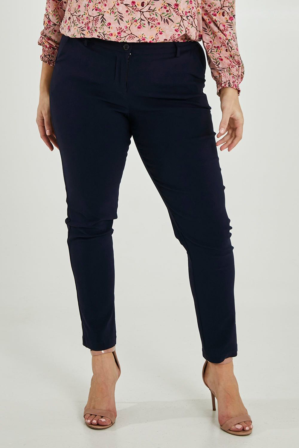 Model Maddy wearing size 16 of The Slim Cut Stretch Pant in colour Navy (Blue), from the front, cropped image