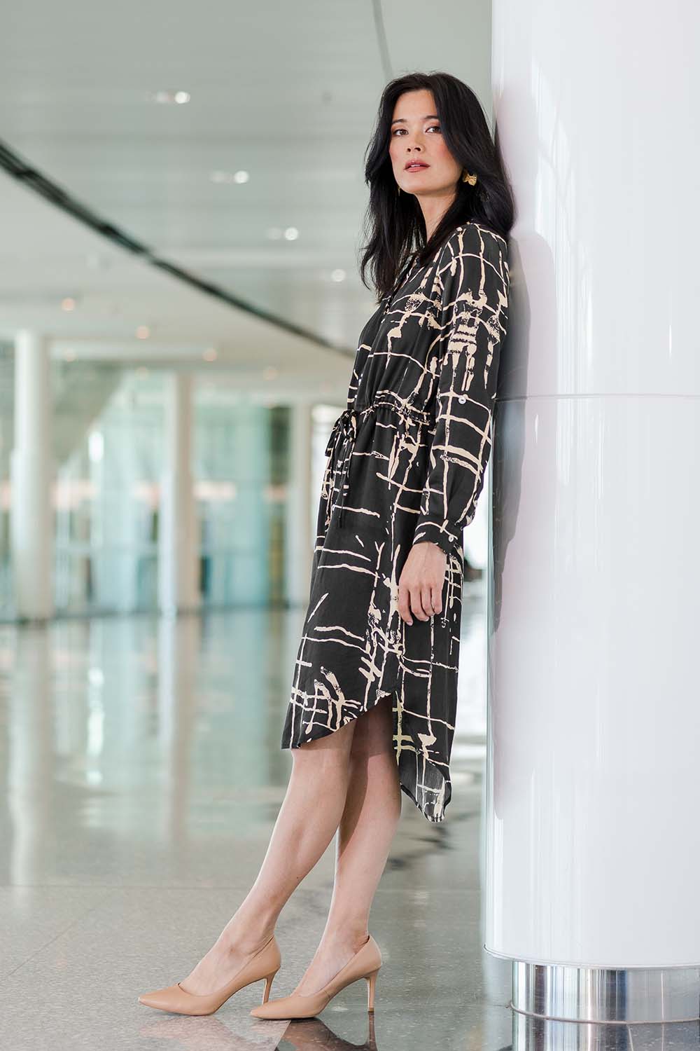 Model Miranda wearing size 10 of The Luxe Viscose Drawstring Dress in colour Sketch (Black), from the front, showing the whole outfit