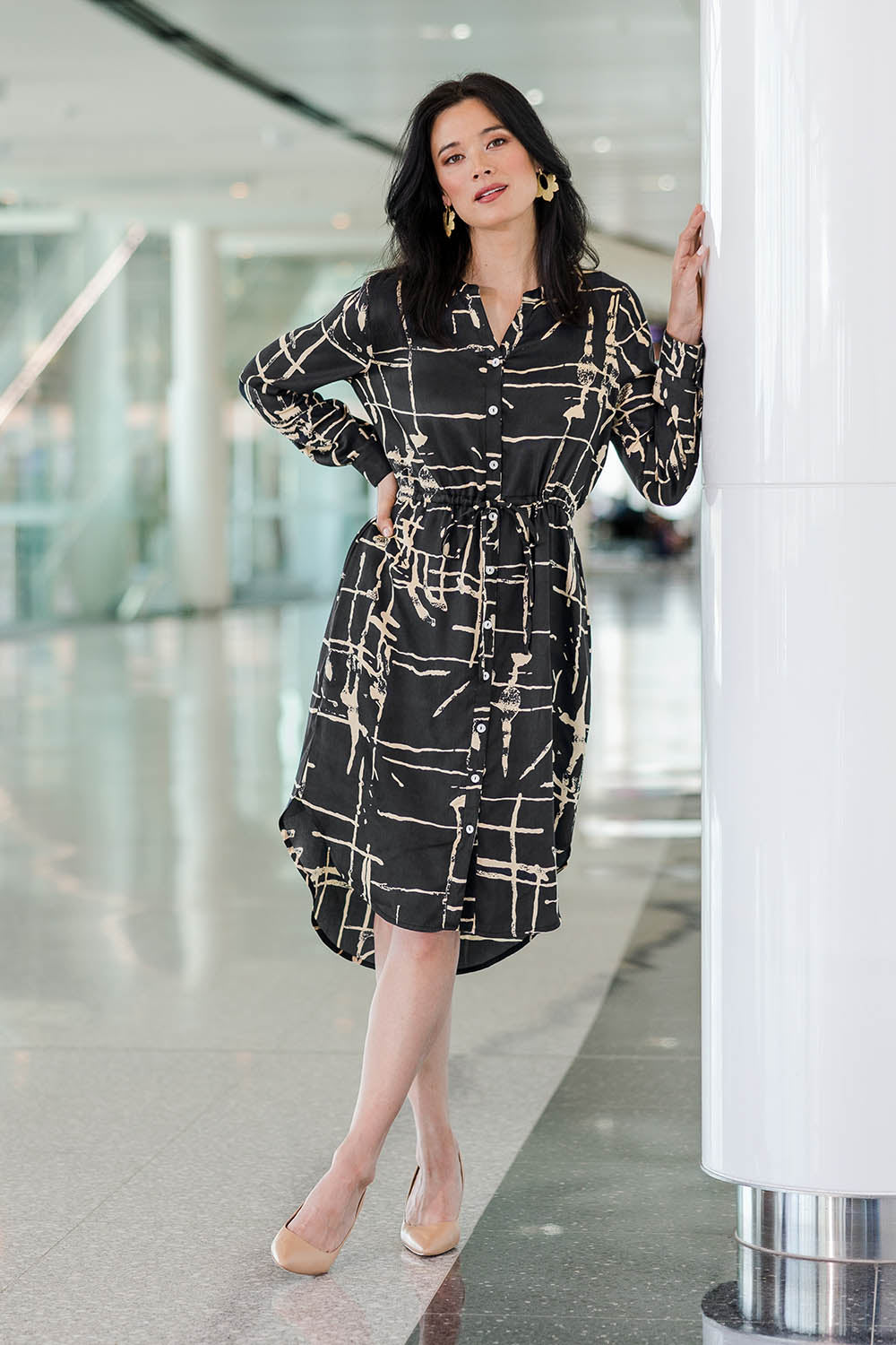 Model Miranda wearing size 10 of The Luxe Viscose Drawstring Dress in colour Sketch (Black), from the front, showing the whole outfit