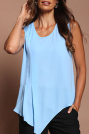 Model Amanda wearing size 10 of The Asymmetrical Tank Top in colour Sky (Blue), from the front, cropped image