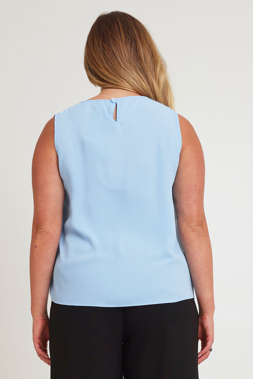 Model Chanel wearing size 16 of The Asymmetrical Tank Top in colour Sky (Blue), from the back
