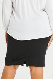 Model Alexis wearing size 16 of The Define Ponte Pull On Skirt in colour Black (Black), from the back