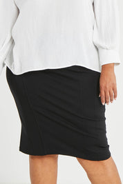 Model Alexis wearing size 16 of The Define Ponte Pull On Skirt in colour Black (Black), from the front, cropped image
