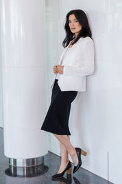 Model Miranda wearing size 10 of The Define Ponte Pull On Skirt in colour Black (Black), from the front, showing the whole outfit