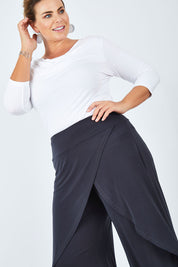 Model Fiona wearing size 16 of The Cross Over Pant in colour Graphite (Grey), from the front, cropped image