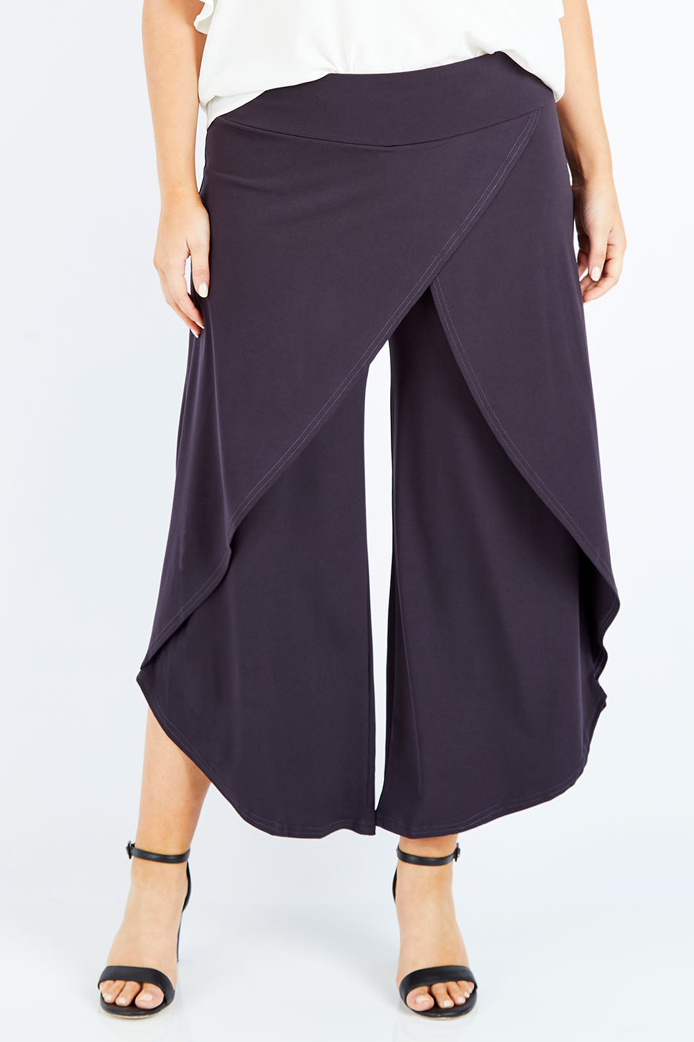 Model Jess wearing size 14 of The Cross Over Pant in colour Graphite (Grey), from the front, cropped image
