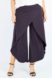 Model Jess wearing size 14 of The Cross Over Pant in colour Graphite (Grey), from the front, cropped image