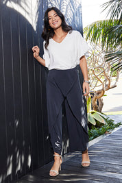 Model Miranda wearing size 10 of The Cross Over Pant in colour Graphite (Grey), from the front, showing the whole outfit