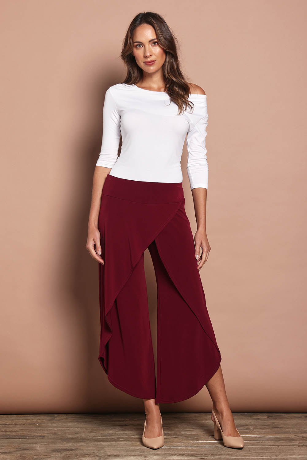 Model Madeline wearing size 10 of The Cross Over Pant in colour Port (Purple), from the front, showing the whole outfit
