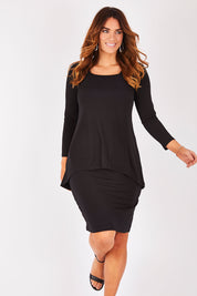 Model Laura wearing size 12 of The Long Rita Dress in colour Black (Black), from the front, showing the whole outfit