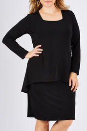 Model Ljubenka wearing size 18 of The Long Rita Dress in colour Black (Black), from the front, cropped image