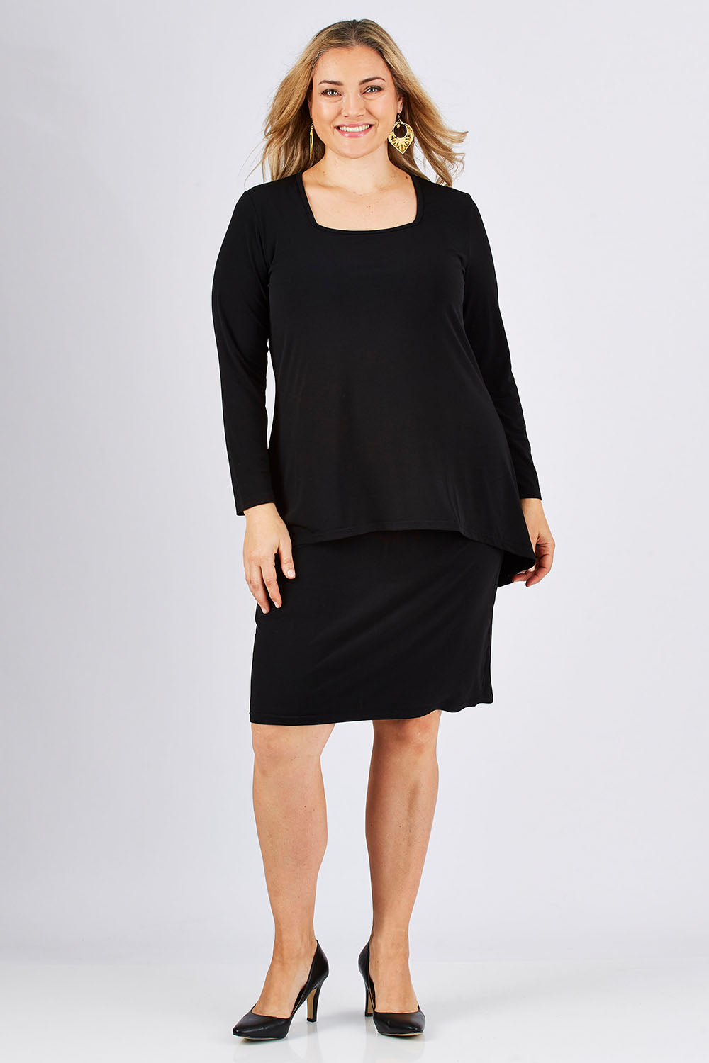 Model Ljubenka wearing size 18 of The Long Rita Dress in colour Black (Black), from the front, showing the whole outfit