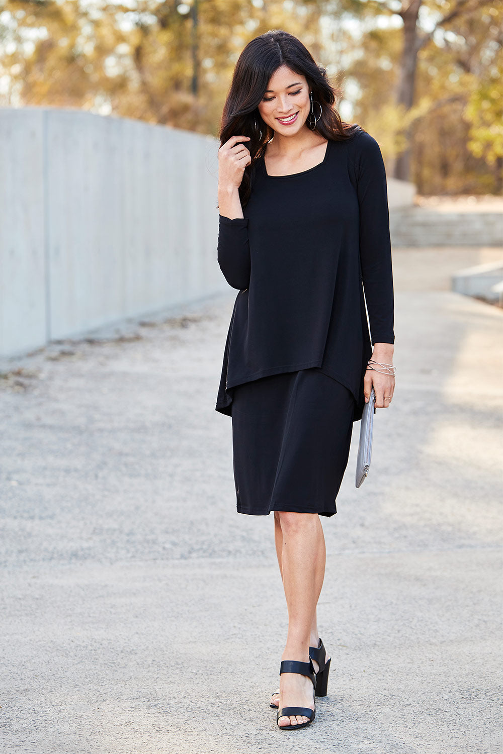 Model Miranda wearing size 10 of The Long Rita Dress in colour Black (Black), from the front, showing the whole outfit