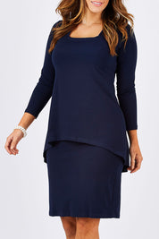 Model Laura wearing size 12 of The Long Rita Dress in colour Navy (Blue), from the front, cropped image