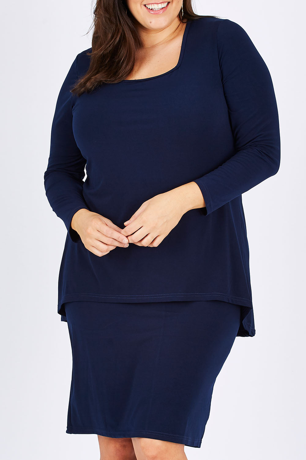 Model Mae wearing size 18 of The Long Rita Dress in colour Navy (Blue), from the front, cropped image