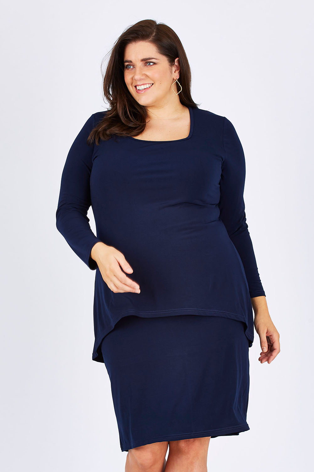 Model Mae wearing size 18 of The Long Rita Dress in colour Navy (Blue), from the front, cropped image