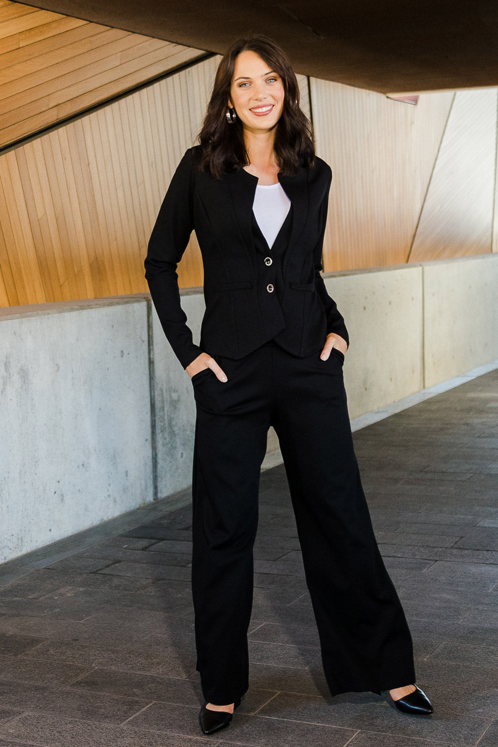 Model Andrea wearing size 10 of The Wide Leg Ponte Pant in colour Black (Black), from the front, showing the whole outfit