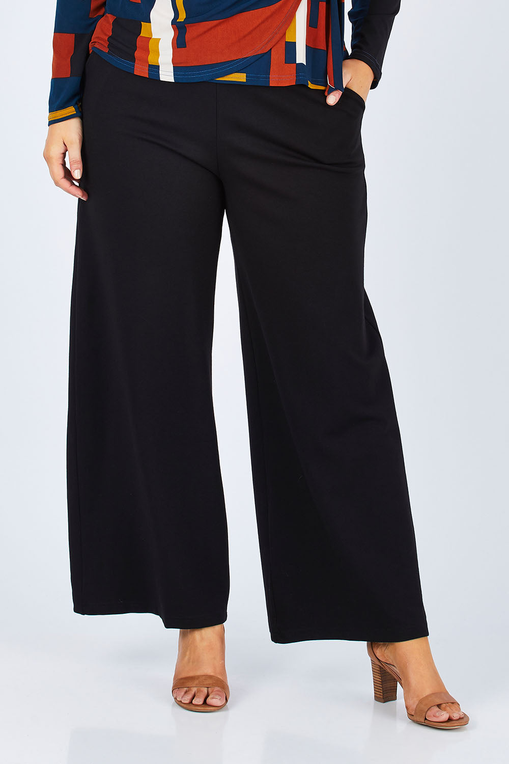 Model Jess wearing size 14 of The Wide Leg Ponte Pant in colour Black (Black), from the front, cropped image