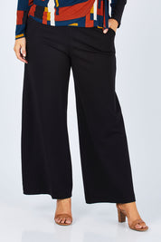 Model Jess wearing size 14 of The Wide Leg Ponte Pant in colour Black (Black), from the front, cropped image