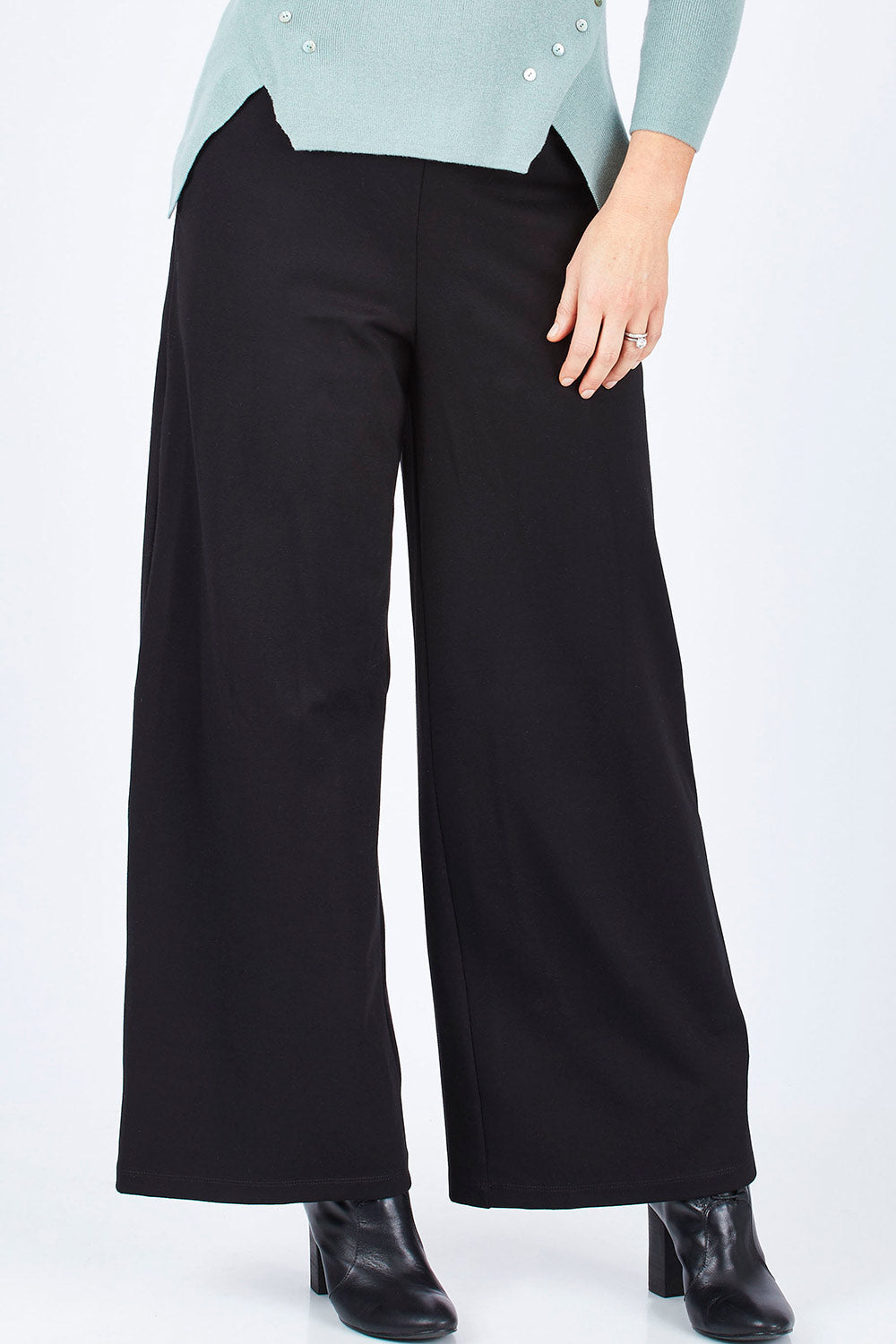 Model Lisa wearing size 10 of The Wide Leg Ponte Pant in colour Black (Black), from the front, cropped image