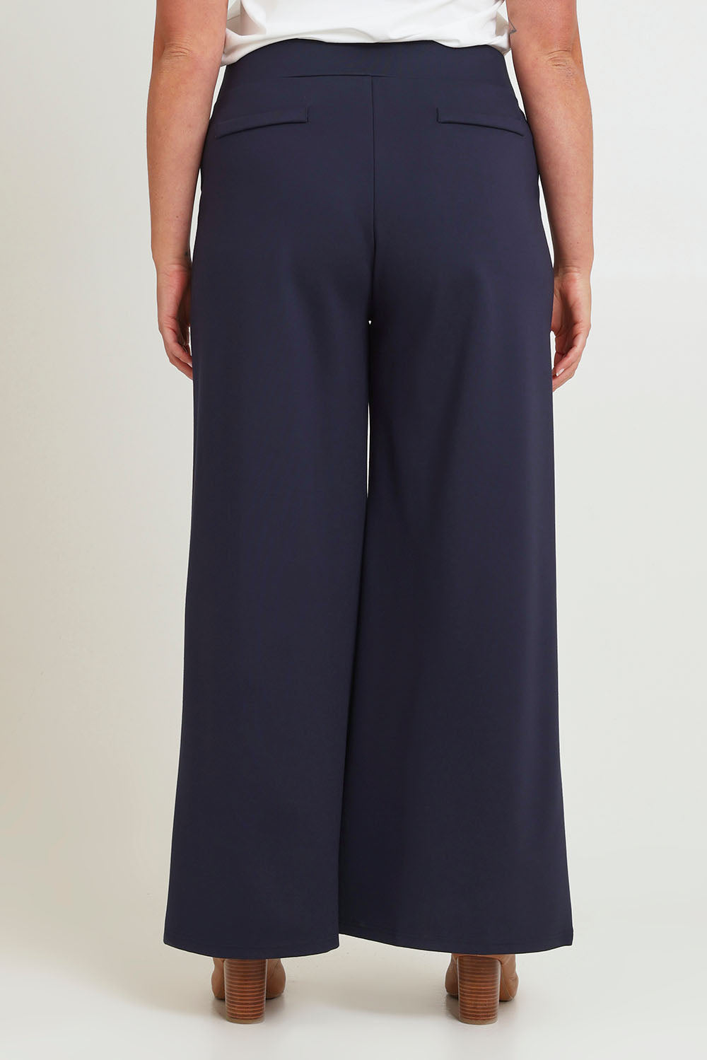 Model Chanel wearing size 16 of The Wide Leg Ponte Pant in colour Darknavy (Blue), from the back