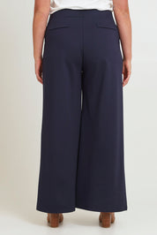 Model Chanel wearing size 16 of The Wide Leg Ponte Pant in colour Darknavy (Blue), from the back