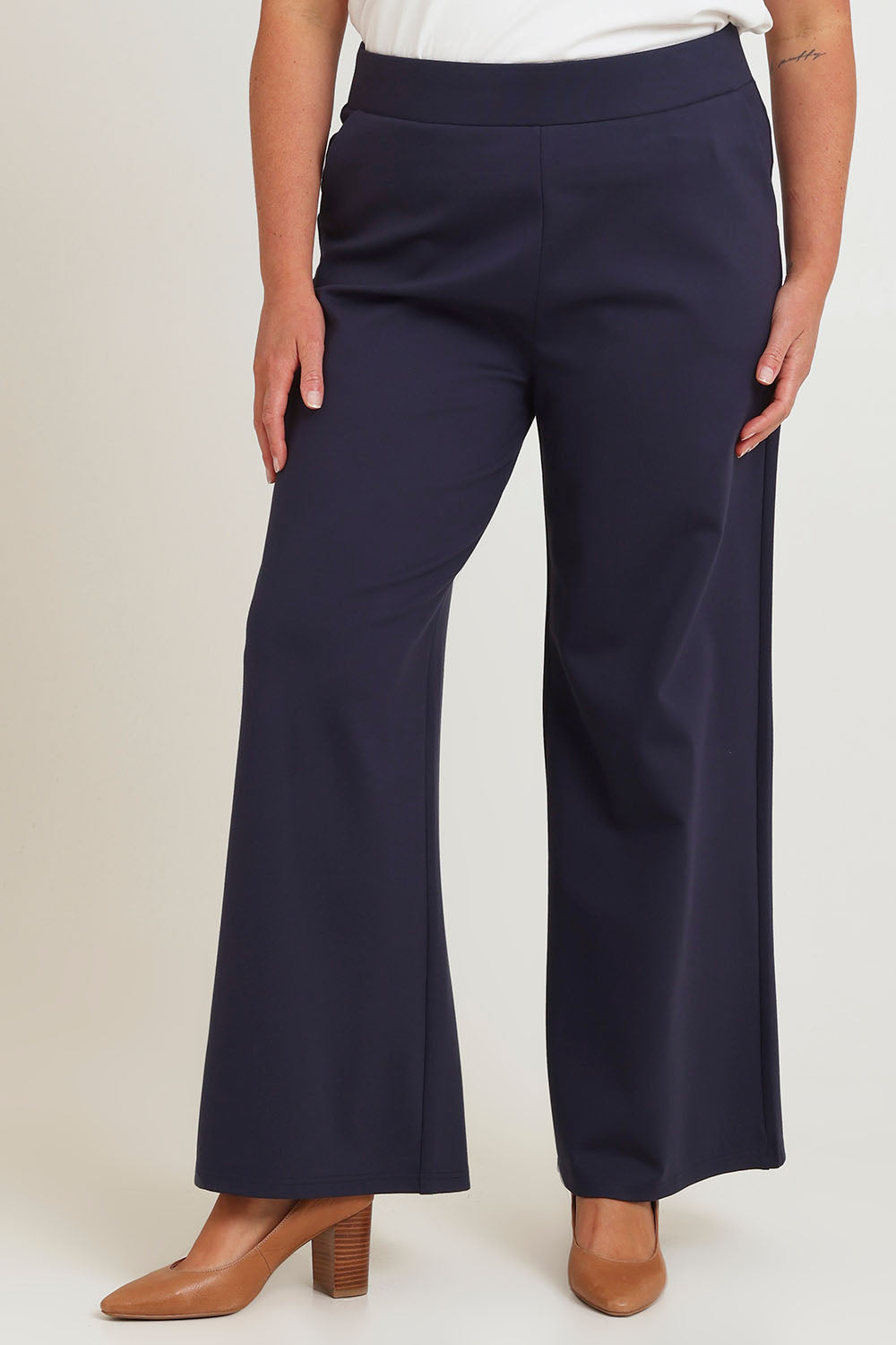 Model Chanel wearing size 16 of The Wide Leg Ponte Pant in colour Darknavy (Blue), from the front, cropped image