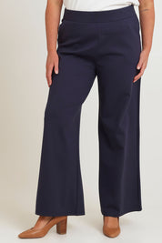 Model Chanel wearing size 16 of The Wide Leg Ponte Pant in colour Darknavy (Blue), from the front, cropped image