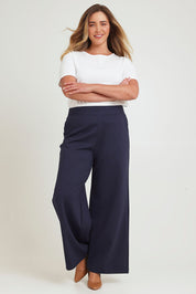 Model Chanel wearing size 16 of The Wide Leg Ponte Pant in colour Darknavy (Blue), from the front, showing the whole outfit