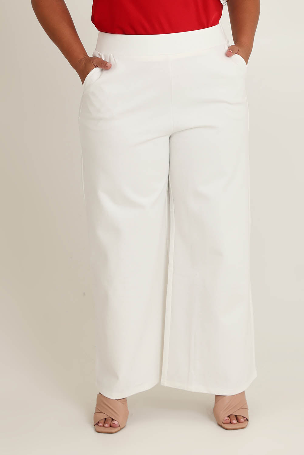 Model Ashleigh wearing size 16 of The Wide Leg Ponte Pant in colour Pearl (White), from the front, cropped image