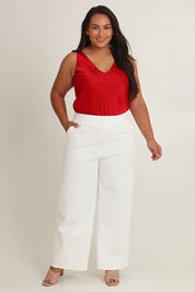 Model Ashleigh wearing size 16 of The Wide Leg Ponte Pant in colour Pearl (White), from the front, showing the whole outfit