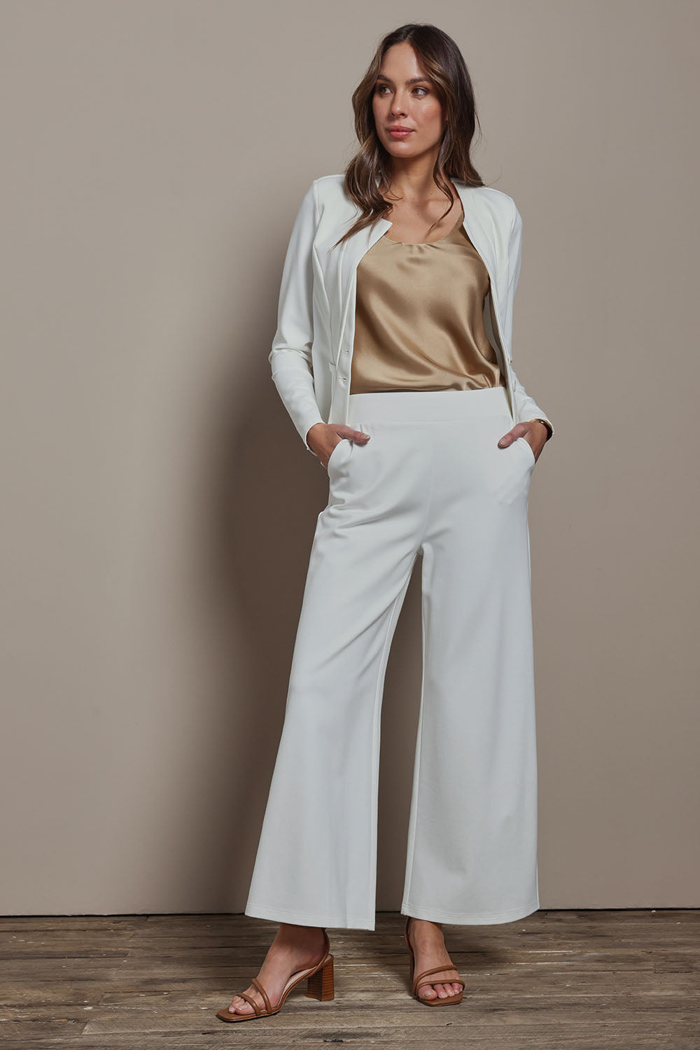 Model Madeline wearing size 10 of The Wide Leg Ponte Pant in colour Pearl (White), from the front, showing the whole outfit