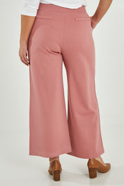 Model Maddy wearing size 16 of The Wide Leg Ponte Pant in colour Rose (Pink), from the back