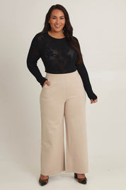 Model Ashleigh wearing size 16 of The Wide Leg Ponte Pant in colour Sand, from the front, showing the whole outfit