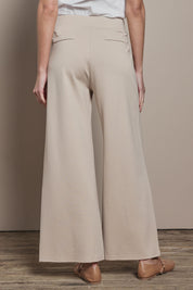 Model Madeline wearing size 10 of The Wide Leg Ponte Pant in colour Sand, from the back