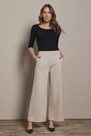 Model Madeline wearing size 10 of The Wide Leg Ponte Pant in colour Sand, from the front, showing the whole outfit
